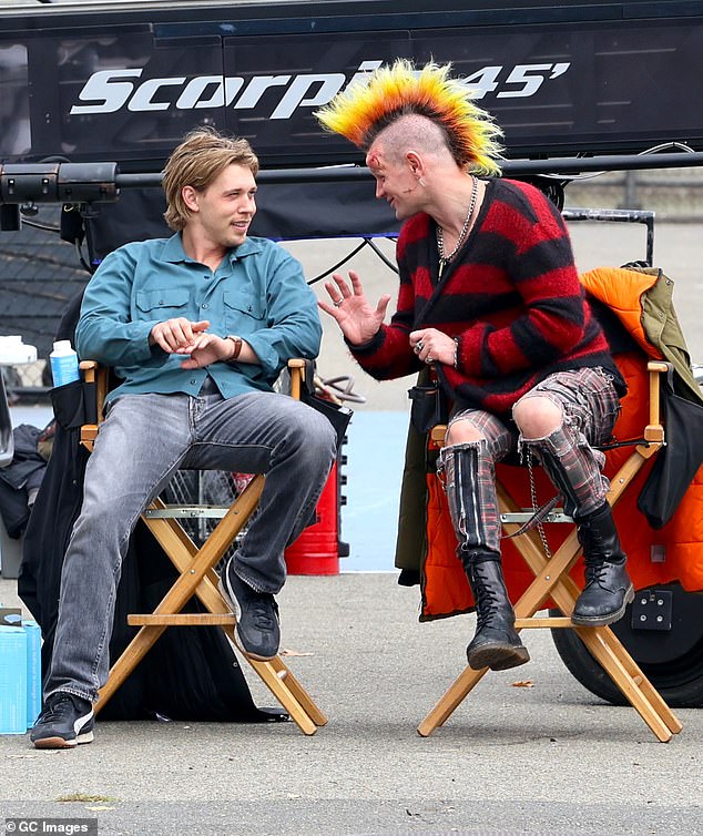 Between takes, Smith wore a red and black flannel sweater as he chatted with his co-star Butler in their chairs on set