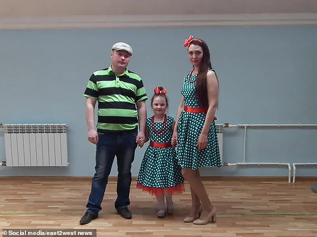 Mikhail Pichugin, 45, with his family, including ex-wife Ekaterina, 38.