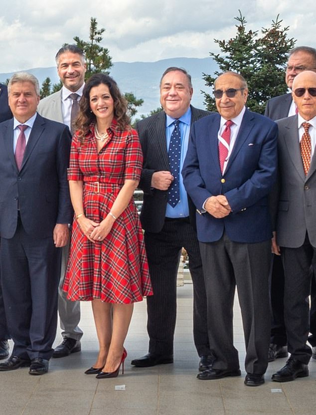 Alex Salmond can be seen smiling happily in the center of what is believed to be his last photo, next to his Alba Party chair Tasmina Ahmed-Sheikh, who is wearing a tartan dress