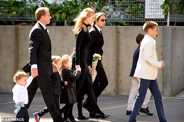 The congregation watched as the hearse drove away, while several of Antony's grandchildren, including youngest daughter Antonia's six children, waved at the departing vehicle.