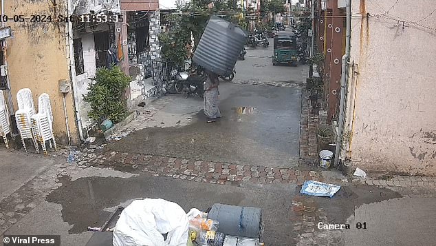 The photo shows the moment just before the water tank fell on her