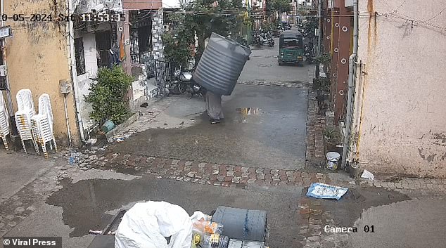 Instead of crushing her, the container landed perfectly on top of the woman and she emerged unscathed