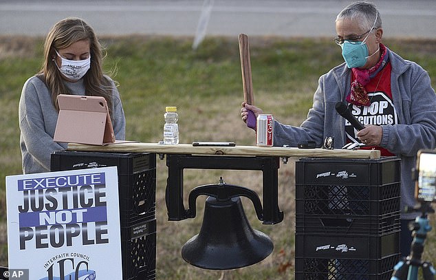 Sister Barbara Battista, right, rings a bell before a minute of silence during a protest against an execution on Terre Haute in 2020