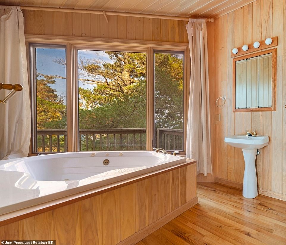 Upstairs is a primary bedroom suite with beautiful views of the surrounding waters and a jetted tub