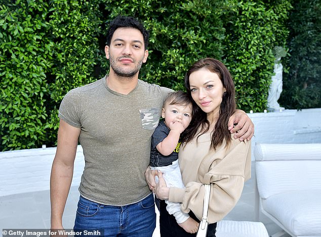 The couple are pictured with their son Titan, now six