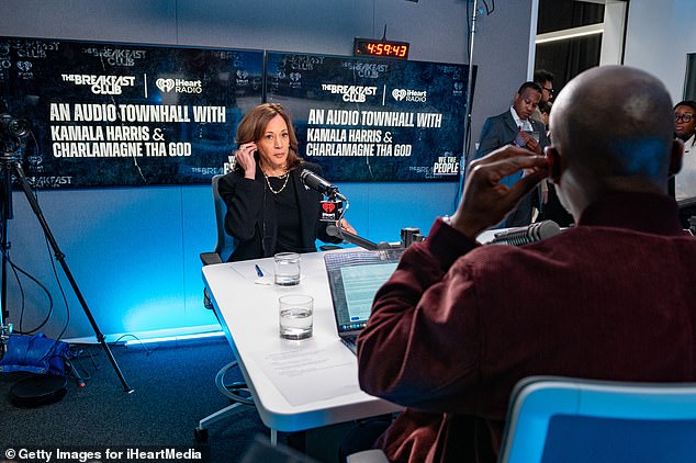 Democratic presidential candidate Vice President Kamala Harris (L) prepares to speak with Charlamagne Tha God