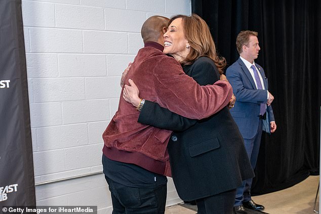 Democratic presidential candidate Vice President Kamala Harris (R) and Charlamagne Tha God embrace prior to their town hall interview in Detroit, Michigan.