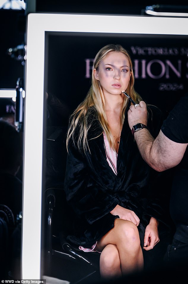 Lila was photographed getting ready backstage in Brooklyn for the Victoria's Secret Fashion show earlier on Tuesday, surrounded by makeup artists