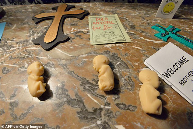 Objects, including small model fetuses, meant to represent an evangelical Sunday school and conversion school, adorn the tables at the Satanic Temple in Salem, Massachusetts