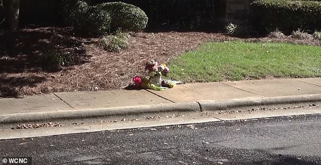 Photos on the side of the road where the father of three was shot dead