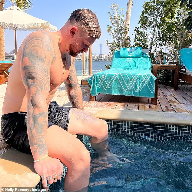 Among her photos from her and Olympian Adam's Dubai trips was one of the swimmers sitting topless by a pool