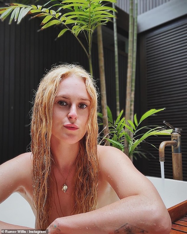 She posed in the bath, covering her modesty with a strategically placed wooden plank and crossing her arms over her chest