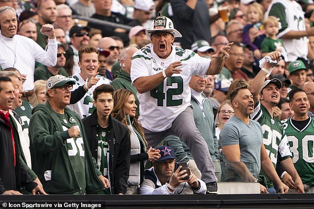 Firefighter Ed leads the crowd in cheering during the first half of a Jets game on October 13, 2019