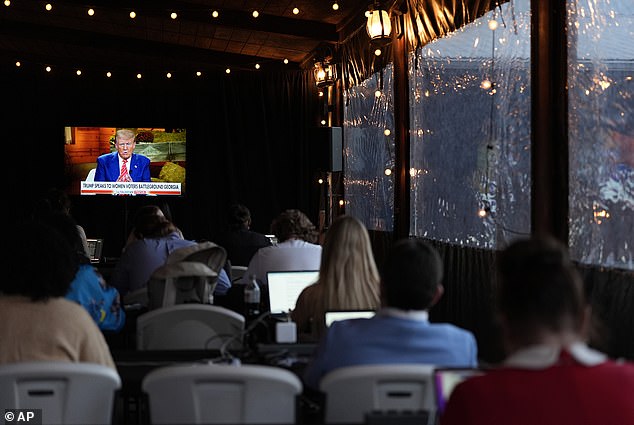 Reporters watch as Republican presidential candidate, former President Donald Trump, speaks during a Fox News town hall with Harris Faulkner at The Reid Barn, Tuesday, October 15, 2024