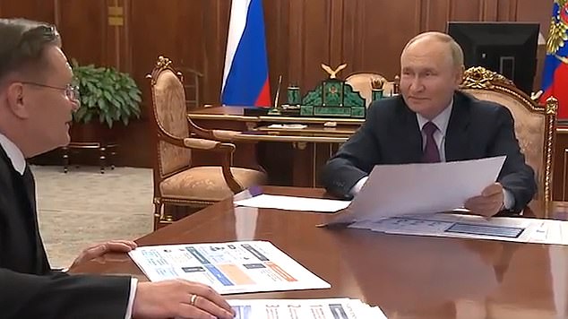 Putin is seen giving a smug smile to Lichachev, but he was quickly taken off the ground by the official who pointed out his mistake