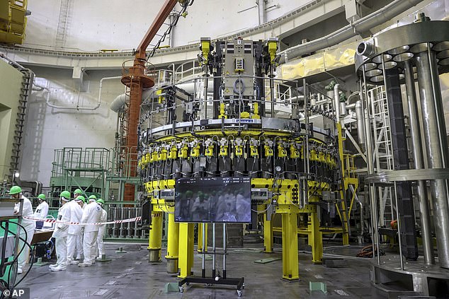 In this Friday, August 7, 2020 file photo, staff work to load nuclear fuel at Belarus' first nuclear power plant, which was built by Russia's state nuclear company Rosatom, near Astravets, Belarus.