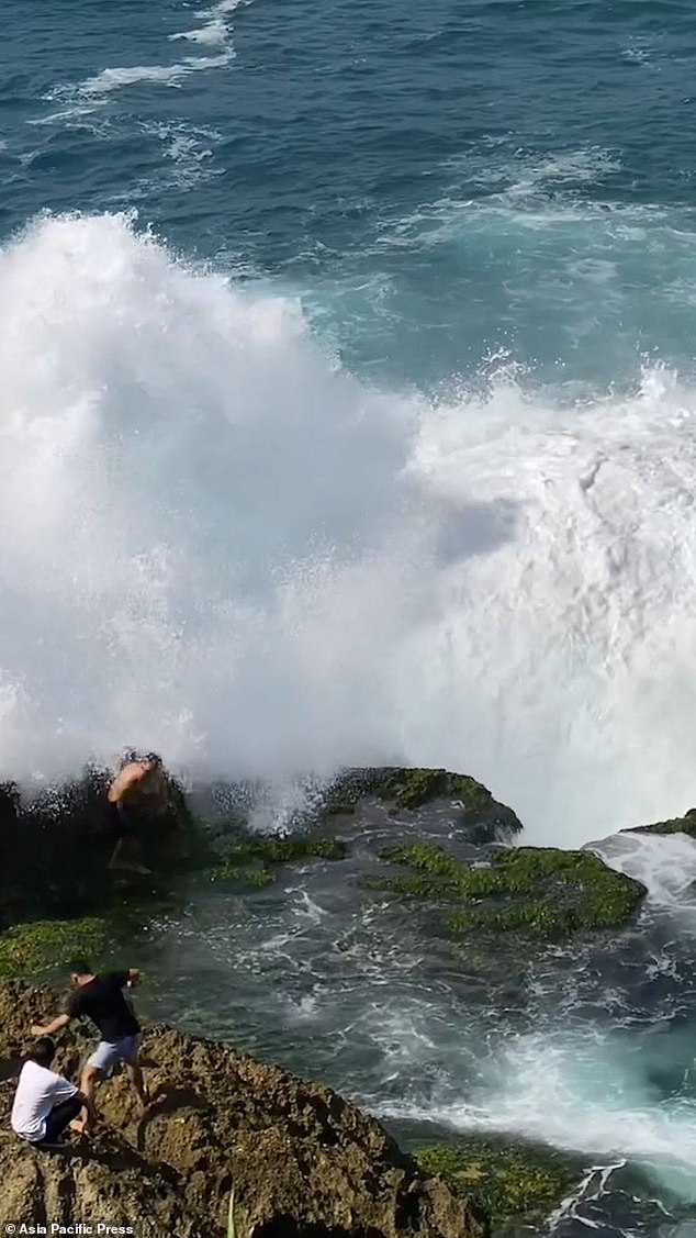 The huge wave crashed into him as his friends watched in horror