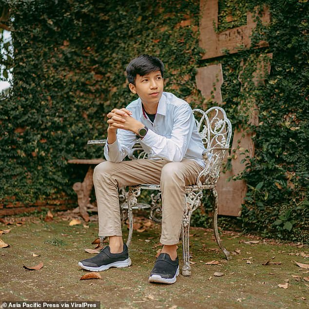 Rony Josua Simanjuntak, 21, from North Sumatra, stood on wet rocks before being washed away by the big wave