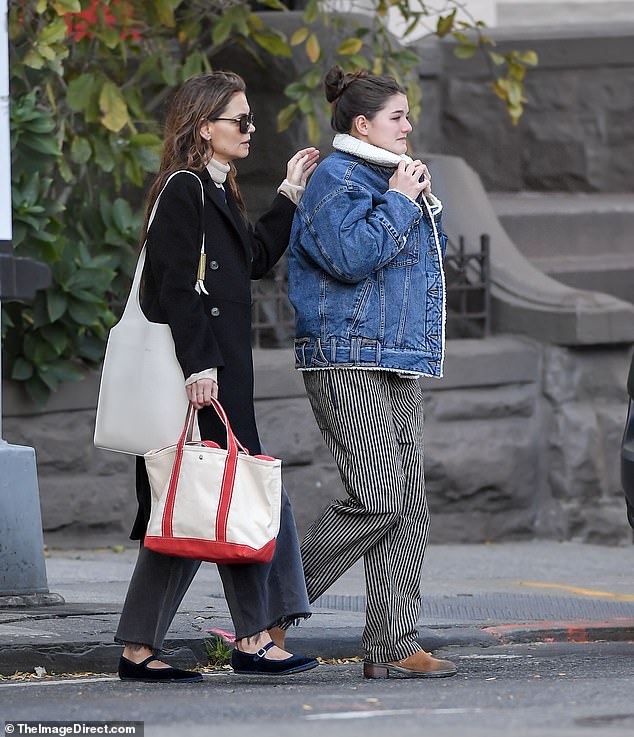 Suri, dressed in a denim sheepskin jacket and striped trousers with tan boots, spent quality time with her mother