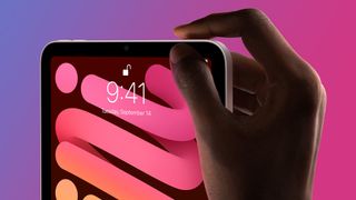 A hand using Touch ID on the iPad mini 6 on a purple and pink background