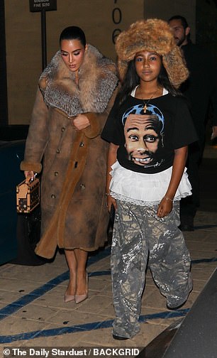 Meanwhile, North, 11, wore an oversized hat with earflaps that matched the color of her mother's coat