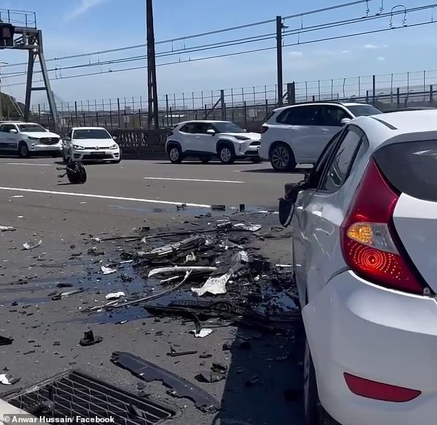 Scrap metal, broken glass and liquid from the crash littered both sides of the road