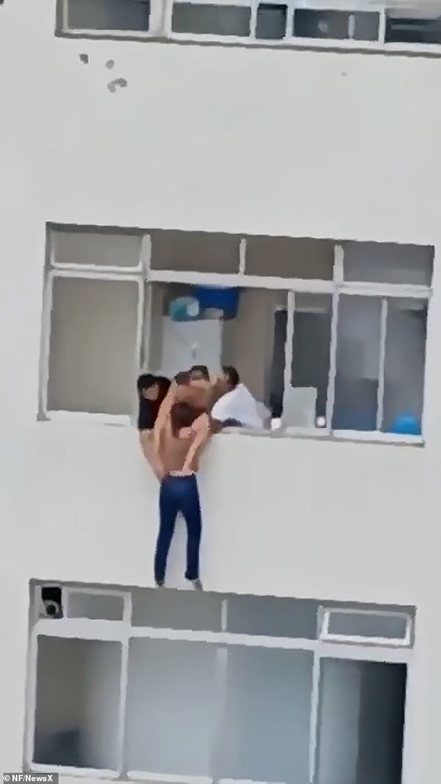 The video shows the cleaner trying to reach the windowsill to pull himself back in, but is unable to do so