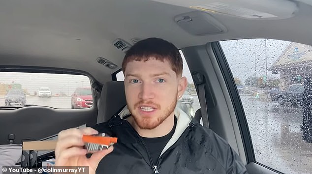 Mr Murray is pictured above trying one of the protein bars while sitting in his car