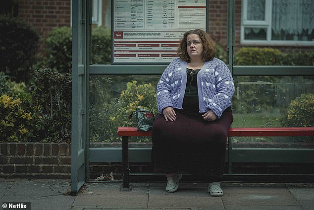 Martha played by Jessica Gunning in the bus stop scene from Baby Reindeer. Fans have scoured the internet for her outfits, including this cardigan with purple hearts