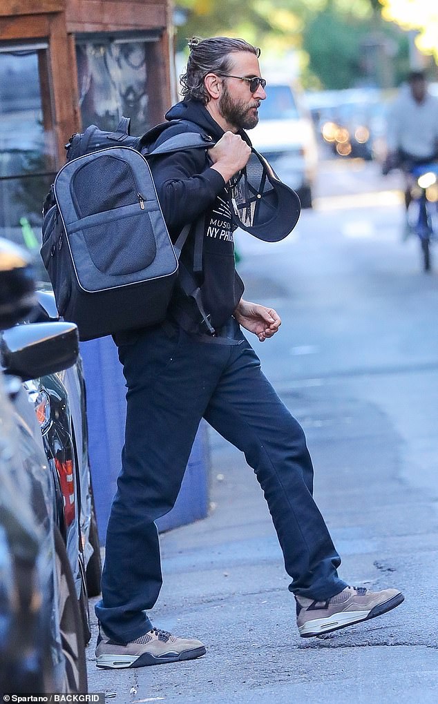 The 49-year-old Maestro filmmaker dressed casually in dark pants, a black sweatshirt and gray Jordan sneakers