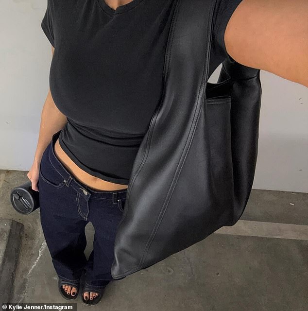 Jenner dressed in an understated black short-sleeved crew-neck T-shirt that showed off her toned stomach