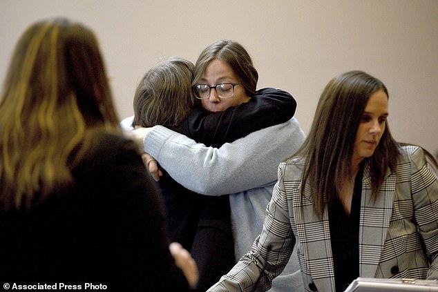 Alexandra Eckersley, who was convicted on charges that she abandoned her newborn baby in the woods, hugs her public defender Kim Cossick