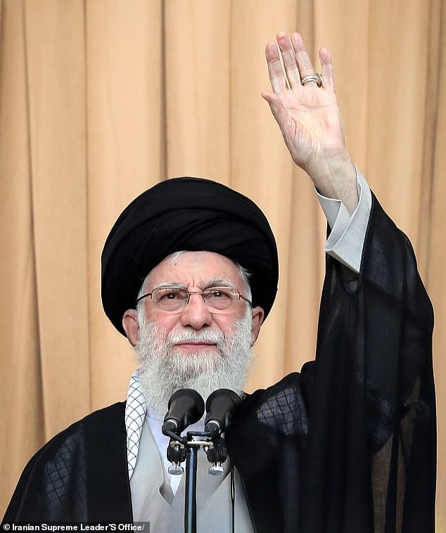 Iranian Supreme Leader Ayatollah Ali Khamenei waves before the Friday prayer ceremony in Tehran