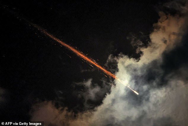 A missile breaks up in mid-air after being hit by an interceptor fired from one of Israel's air defense systems