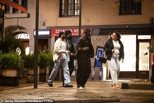 Mbappe (wearing a black hat and face mask) is seen with his entourage outside the Chez Jolie restaurant