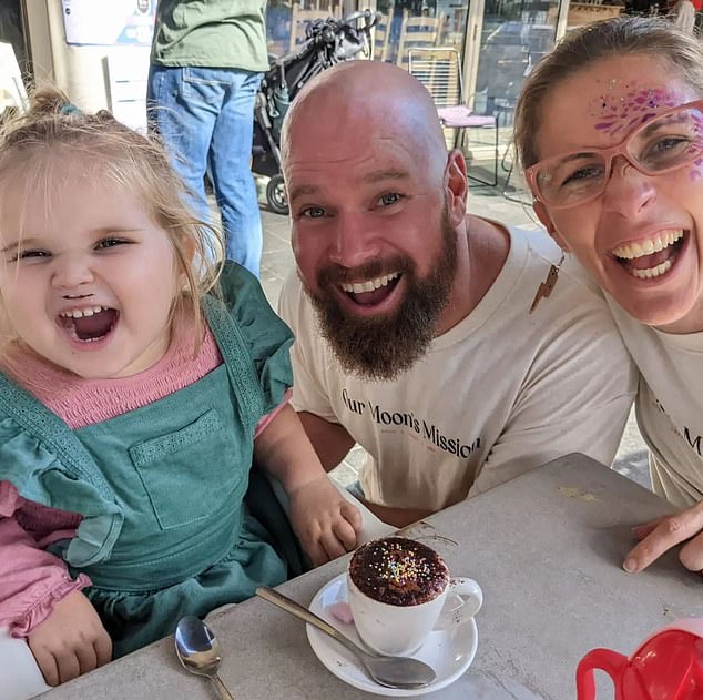 Tallulah is pictured above with her parents. Her mother described her daughter looking at her parents as if asking why they couldn't help her