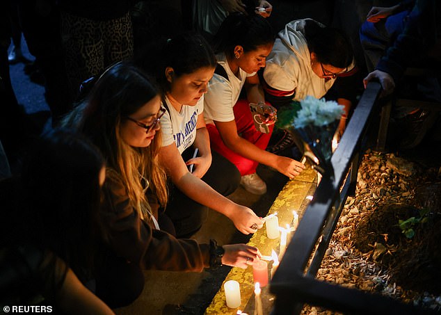 Fans place candles outside the hotel where Liam Payne was found dead