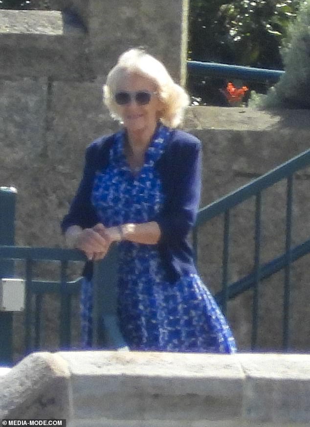 Camilla chose a dark blue summer dress and matching cardigan