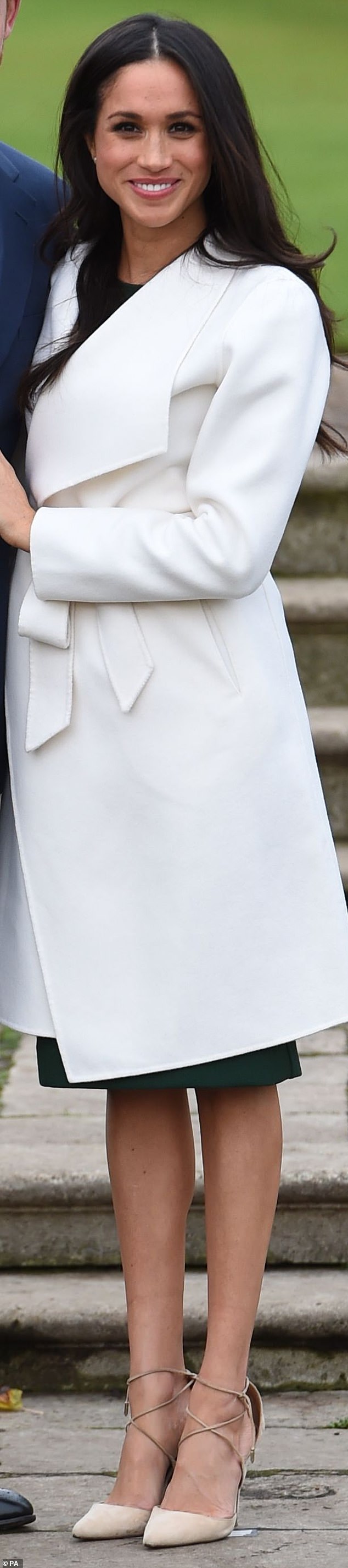 Meghan in a white belted coat from Line The Label and pale Aquazzura shoes in 2017