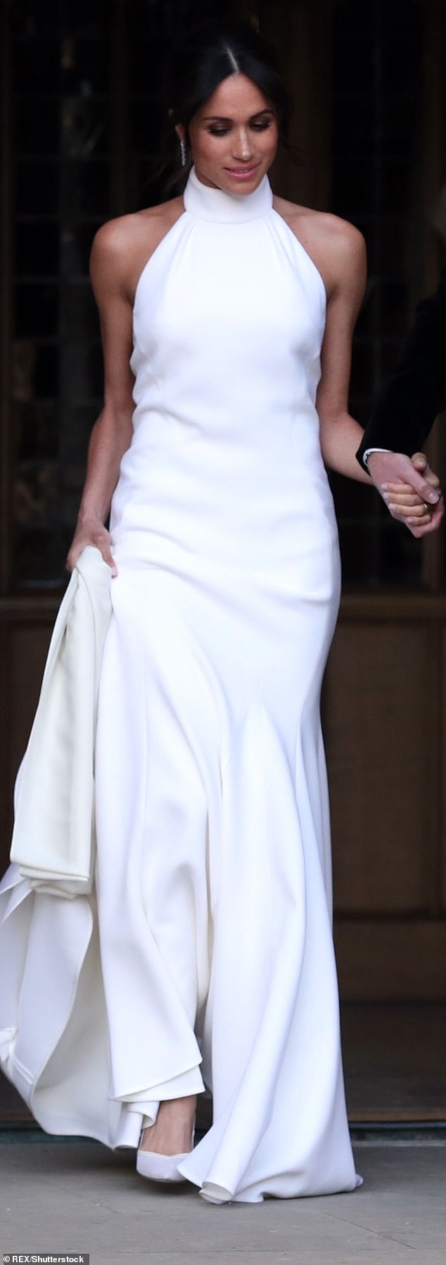 The Duchess wore this Stella McCartney halter dress to her wedding reception - it showed off Meghan's Pilates-honed shoulders