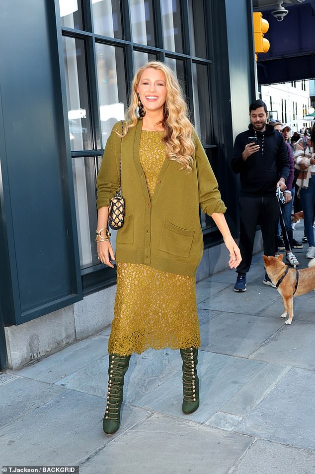 The actress styled her signature long golden locks in waves and teamed her chic look with a black and gold designer bag