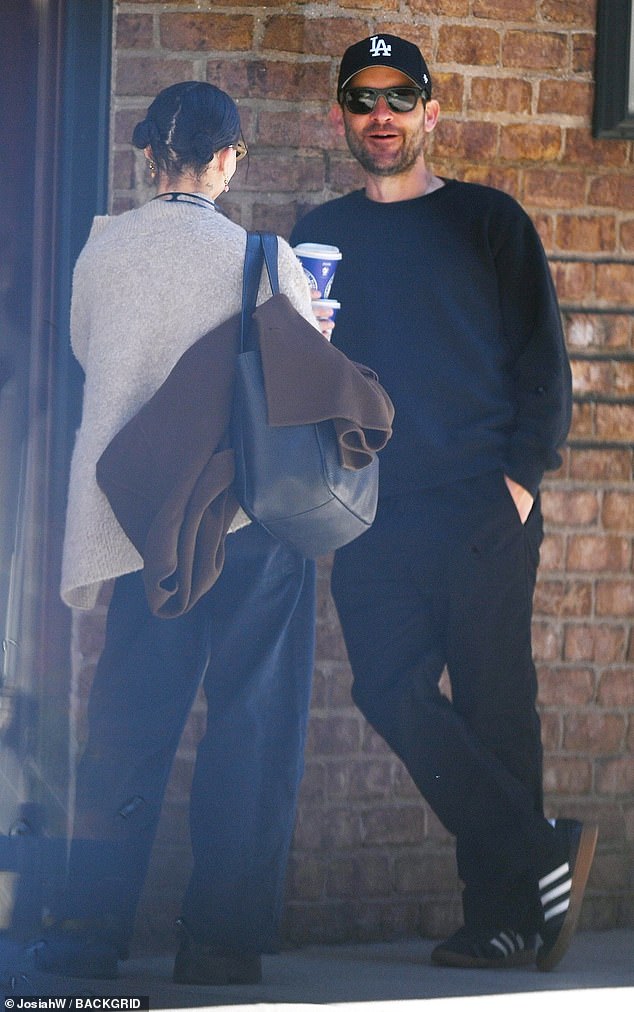 Kravitz wore loose-fitting indigo blue jeans with a light gray vest and black boots, while Tobey was dressed in black pants and black and white Adidas sneakers