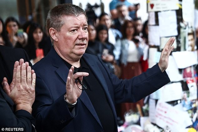 Geoff Payne, father of former One Direction bandmate Liam Payne, waves to people outside the hotel where Liam Payne was found dead