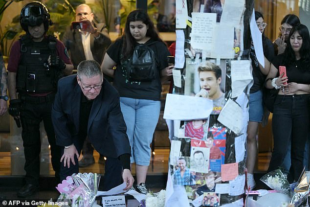 Geoff Payne (left), the father of One Direction pop singer Liam Payne, looks at where fans paid tribute to his late son outside the CasaSur Hotel