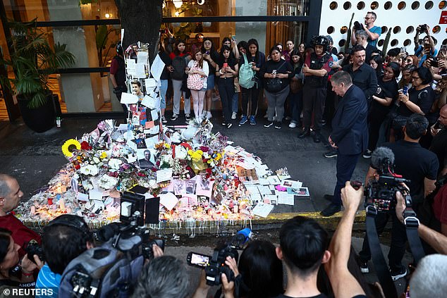 Geoff Payne stands at a makeshift memorial outside the hotel where his son Liam Payne was found dead