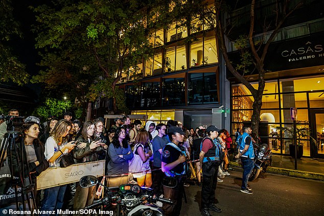 Fans wait outside the hotel on Wednesday following the star's shocking death