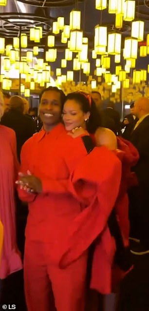 Rihanna grinned as she hugged her partner from behind, before wrapping her arm around him and nuzzling into his neck for another photo