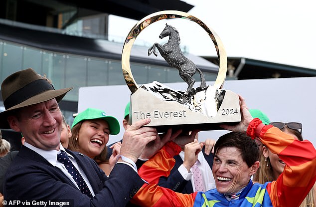 Jockey Craig Williams (pictured right), rider of Bella Nipotina and trainer Cairon Maher (pictured left) collect the Everest 2024 trophy at Royal Randwick