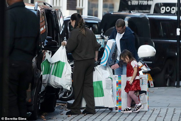 The 40-year-old millionaire socialite cut a casual figure and went makeup-free for the outing, where she was helped by her entourage as she carried several large bags to her waiting car.