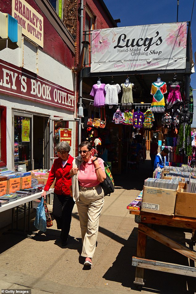 In addition to affordability, Pittsburgh offers a rich array of cultural attractions, dining options and outdoor activities (Photo: Two adults shopping in the used book and clothing stores and selling on the sidewalks in Pittsburgh's Strip business district)